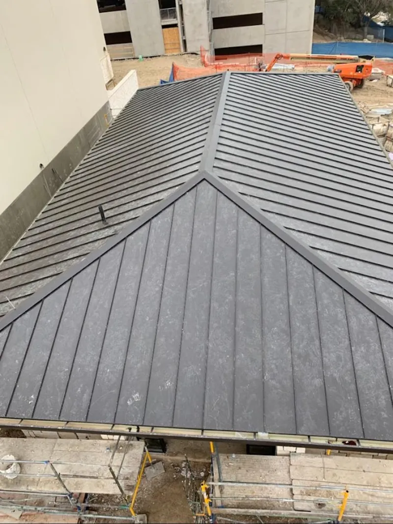 Commercial metal roof construction with crane equipment in Fort Wayne