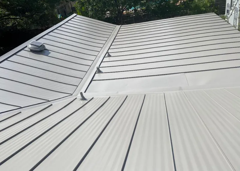 Solar attic fan installed on a metal roof for Roof Ventilation in Fort Wayne